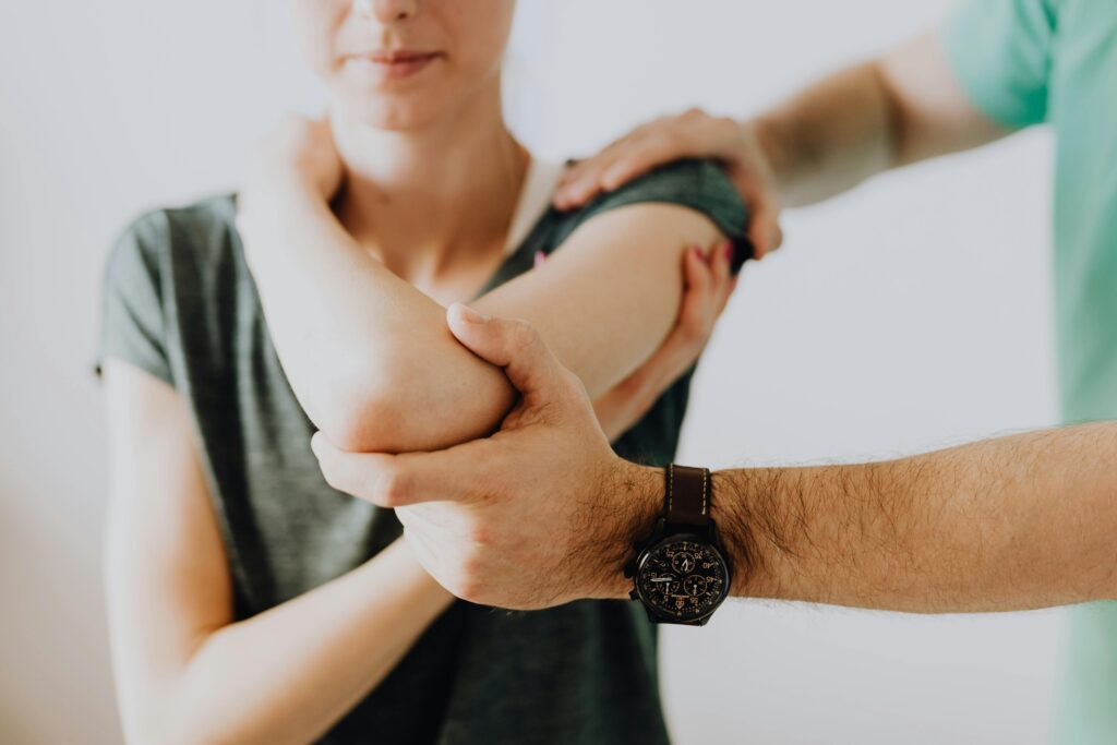 doctor examining a patient's shoulder