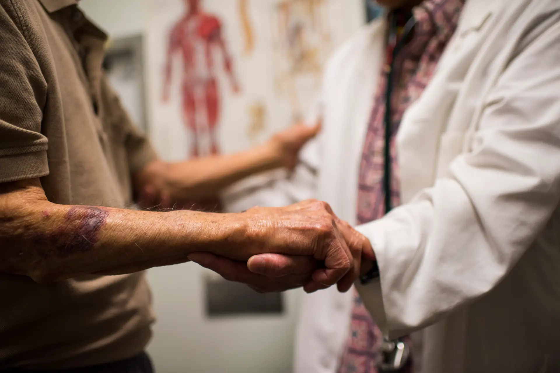 Doctor holding patient's hand